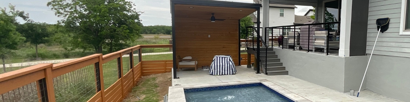Finished steel patio cover with Tricorn Black finish and pine tongue-and-groove ceiling.