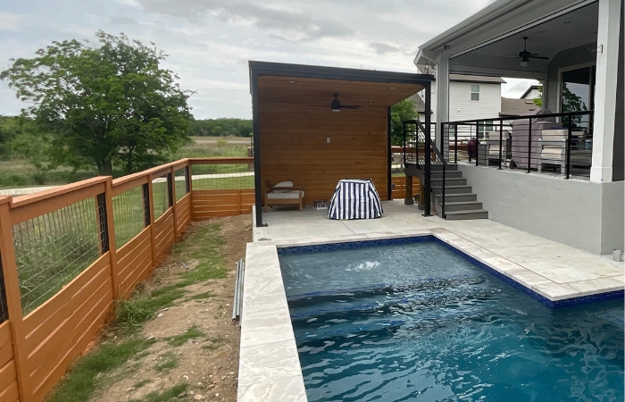 Finished steel patio cover with Tricorn Black finish and pine tongue-and-groove ceiling.