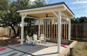Finished single-pitch patio cover with standing seam metal roof and pine tongue-and-groove soffit.