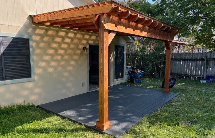 Trex Clamshell floating deck installed beneath the cedar pergola.