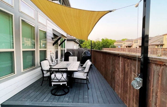 Completed Trex Clamshell deck with a stretched Sun Sail providing shade.