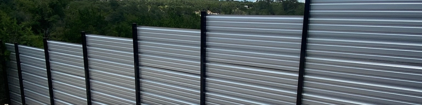 Custom horizontal R-Panel fence with sleek steel posts for a modern finish.