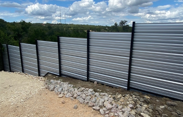 Custom horizontal R-Panel fence with sleek steel posts for a modern finish.